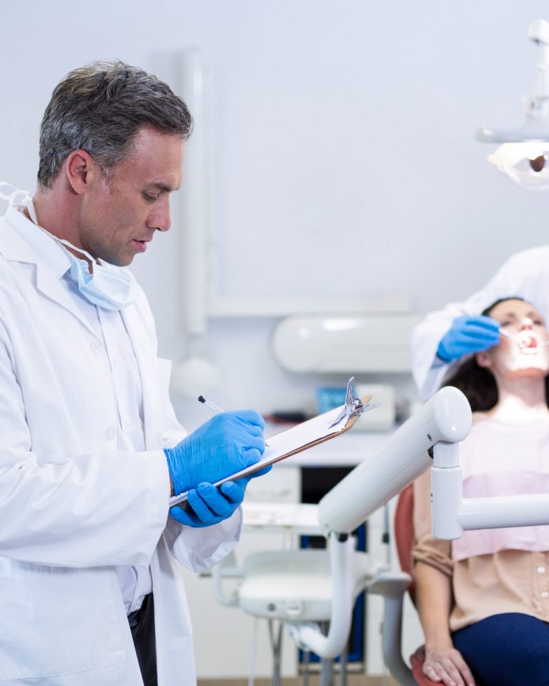 dentist writing on clipboard peh20kzr2bjqsbbenne9hclz2u18577nczzvlr4avk